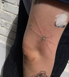 a person with a tattoo on their arm that has the sun and stars in it