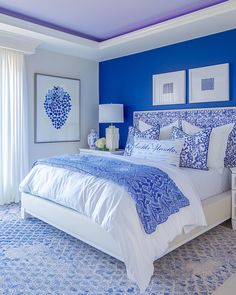 a bedroom with blue walls and white furniture