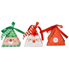 three small christmas gift bags with bows and santa's face on the top one