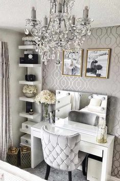 a bedroom with a white desk and chandelier