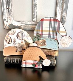 three hats sitting on top of each other next to an old wooden chair and window frame