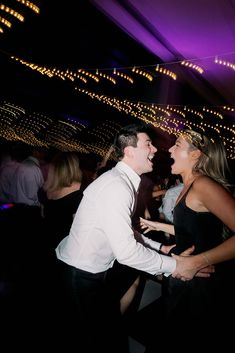 a man and woman dancing at a party