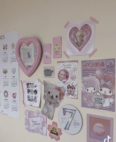 the wall is covered with pink and white pictures, magnets, and other items