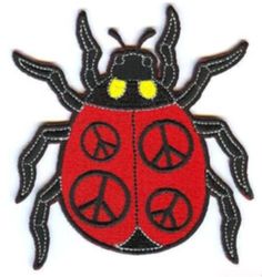 a red and black bug with peace signs on it