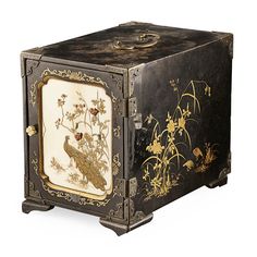 an ornate black box with birds and flowers painted on the front, gold trimmings