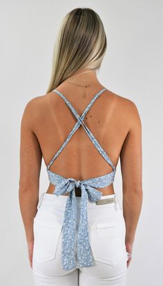 Great trendy little top. This tiny triangle crop top has adjustable straps that cross in the back for support and a back tie that customizes the fit. Wear it with a skirt for a delicate look, or pair it with your favorite jeans to add some edge. Color-Light Blue Floral (Also available in Gold Floral) 100% Rayon Chic Crop Top With Built-in Bra And Strappy Back, Vacation Tops With Tie Back And Backless Shape, Vacation Tops With Tie Back And Backless Design, Vacation Backless Top With Tie Back, Vacation Tie Back Backless Tops, Casual Crop Top With Built-in Bra And Strappy Back, Spring Backless Halter Top With Built-in Bra, Chic Triangle Crop Top With Built-in Bra, Trendy Triangle Crop Top With Built-in Bra