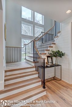 a staircase in a home with wood floors and white walls