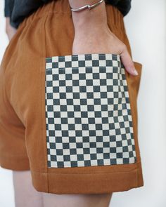 a close up of a person's shorts with a checkered pocket