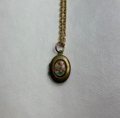 "This sweet, small, OVAL antique brass locket has a vintage Guilloche pale pink enamel cabochon with pink flowers set on the front, giving it the perfect cottage core feel.  It hangs on a 16\" gold stainless steel chain necklace.  The locket is approximately 11x16mm.  The enamel cabochon is 6x8mm.  Arrives in an eco-friendly jewelry box, ready for gifting. MORE lockets in my shop! FREE SHIPPING! THANK YOU FOR VISITING MY SHOP!" Vintage Oval Necklace Personalized, Vintage Oval Adjustable Necklace, Vintage Rose Gold Oval Locket Necklace, Bronze Oval Necklace For Vintage Collection, Bronze Oval Locket Necklace Gift, Bronze Oval Necklaces With Vintage Charm, Vintage Gold Jewelry Aesthetic, Locket Necklace Aesthetic, Gothic Locket