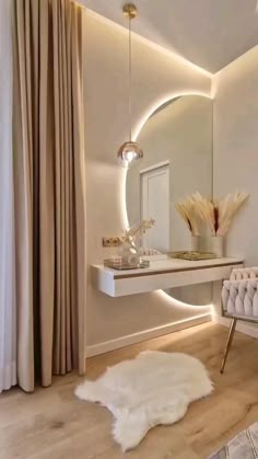 a white chair sitting in front of a mirror on top of a wooden floor next to a table