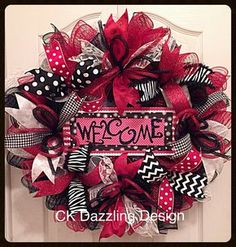 a red and black welcome wreath with polka dots, chevrons, and ribbon