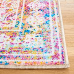 a multicolored area rug on a wooden floor