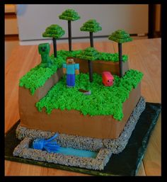 a cake made to look like an island with trees and animals on it, sitting on top of a wooden table