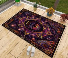 a rug with an image of the eye and stars on it in front of a wooden floor