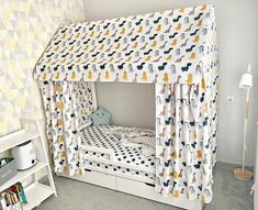 a child's bed with a canopy and curtains