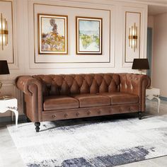 a brown leather couch sitting on top of a white rug