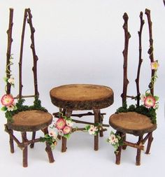 three wooden chairs and two tables made out of tree trunks with flowers on them, sitting next to each other