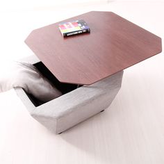 a table with a book in it sitting on top of a wooden box that is open