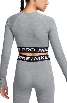 Nike Pro lettering details the stretchy, cropped hem of a second-skin top designed with sweat-wicking Dri-FIT tech that helps you stay dry and comfortable. 13 1/2" length (size Medium) Crewneck Long sleeves with thumbhole cuffs Dri-FIT moisture-wicking technology 83% polyester, 17% spandex Machine wash, dry flat Imported Functional Sports Crop Top With Crew Neck, Functional Crew Neck Crop Top For Sports, Go-dry Cropped Sports Top, Nike Athleisure Crop Top For Sports, Nike Athleisure Crop Top For Gym, Nike Sporty Crop Top For Workout, Nike Sports Crop Top, Nike Functional High Stretch Tops, Nike Stretch Sports Crop Top