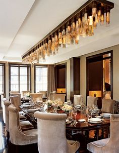 an elegant dining room with chandelier and chairs