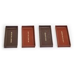 three chocolate bars sitting next to each other on a white surface