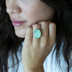 We are loving this oval chrysoprase ring, cradled in a loving embrace of a double-shank silver band. The genuine chrysoprase stone, with its calming shades of green, exudes serenity and elegance. As you slip this ring onto your finger, you'll feel a deep connection to the Earth's natural wonders, as the chrysoprase's ethereal hues seem to capture the essence of a lush forest glade or a tranquil emerald lake. Gemstone - Genuine Chrysoprase 950 Sterling silver High polish finish Approx. 0.8" L x 0 Forest Glade, Loving Embrace, Chrysoprase Ring, Lush Forest, Emerald Lake, Deep Connection, We Are Love, Natural Wonders, Silver Band