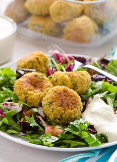 the cover of clean eating recipes cookbook is shown on a plate with salad and meatballs