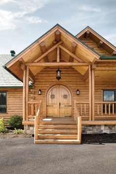 a log cabin with steps leading up to the front door