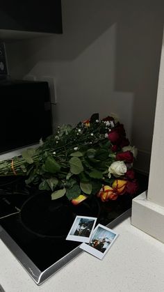 flowers and pictures are sitting on the counter