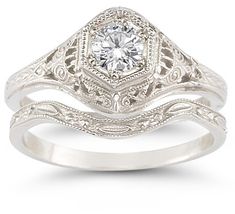 a white gold engagement ring set with an old - fashioned style diamond in the center