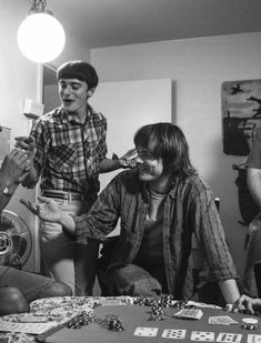 a group of people playing cards in a room