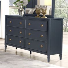 a blue dresser and mirror in a room