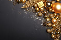 gold and black christmas decorations on a dark background with copy - space for your text