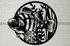 a fish is shown in the middle of a circle on a white brick wall with plants