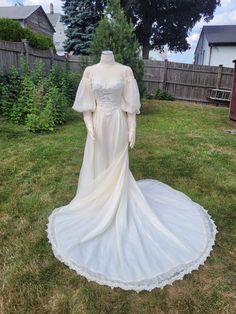 a wedding dress on display in the yard