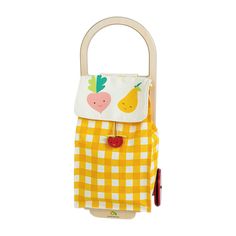 a yellow and white checkered bag with fruits on the front, hanging from a hook