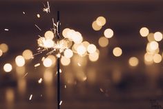 a sparkler that is sitting on top of a table with lights in the background