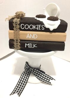 stack of cookies and milk sitting on top of each other in a white pedestal bowl