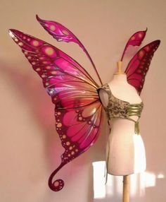 a dress form with a pink butterfly wings on it