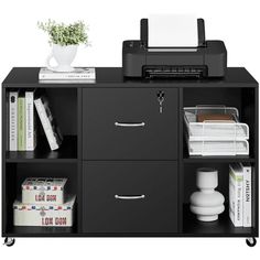 an office desk with printer, books and other items on the shelf next to it