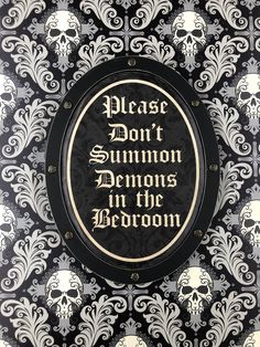 a black and white wall with a sign on it that says please don't summon demons in the bedroom