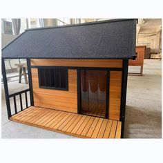 a small wooden house sitting on top of a hard wood floor