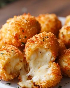 some fried food on a white plate with parmesan cheese