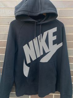 Vintage 1990s Nike Swoosh Graphic Hoodie / 90s Hoodie / Vintage Sweater / Athletic Pull Over / Vintage Nike Mid Swoosh Hoodie - Size L (Length 27" Chest 20") - Overall great vintage condition - Great black fade on it - Perfect for fall - Message me for precise measurements/more information Please take note of the measurements listed as these are vintage clothes and may fit different than the tag size. Follow our page for more vintage clothing drops! Connect with us on Instagram: @recurarchives Nike Pull Vintage, Nike Mid, Pull Vintage, 90s Hoodie, Black Fade, Vintage Pullover, 90s Nike, Nike Sweater, Fade To Black