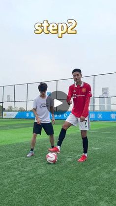 two young men are playing soccer on the field with one man in red and white