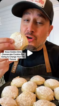 a man is eating some cookies and looking at the camera while wearing an old - fashioned hat