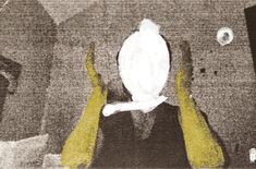 two hands holding up a white object in front of a black and white photo with yellow accents