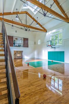 an indoor basketball court with hard wood floors