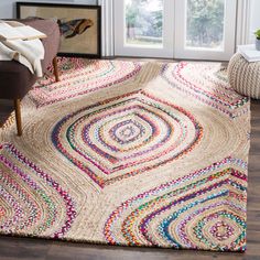 an area rug with multicolored circles on the floor in front of a window