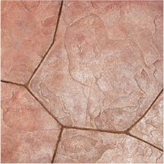 a close up view of the surface of a stone floor with cracks and dirt on it